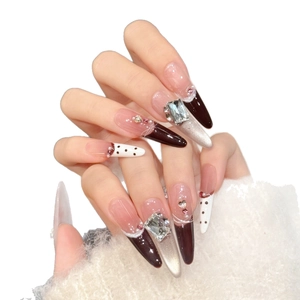 Long stiletto press-on nails in caramel cocoa and silver cat-eye with luxury rhinestones