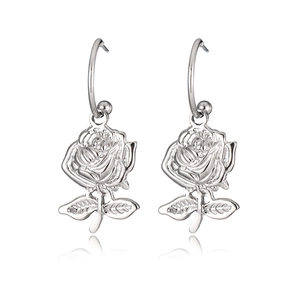 Detailed close-up of elegant silver rose drop earrings with polished metallic finish