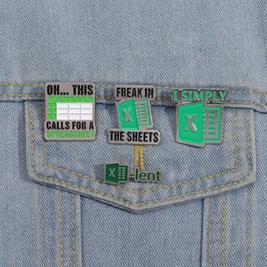 Close-up of four spreadsheet geek enamel pins pinned on a blue denim jacket pocket