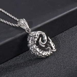 Gothic punk skull monster pendant in stainless steel with textured scales on a silver chain