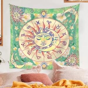 Detail of tarot style sun and moon tapestry with zodiac symbols hanging on a bedroom wall