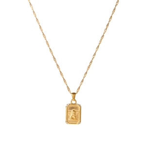 Golden stainless steel angel pendant necklace with a fine water wave chain on white background
