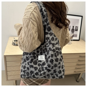 Detail view of large leopard print plush tote bag with white woven label patch