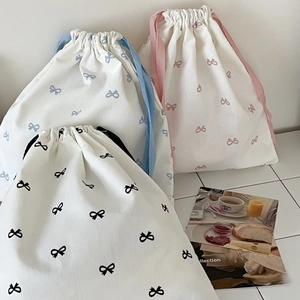 Three cotton canvas drawstring bags with sweet bow prints in blue, pink, and black colors