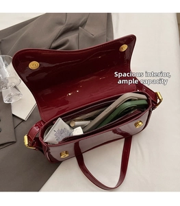 Detail view of burgundy patent leather bag interior showing spacious storage for daily items