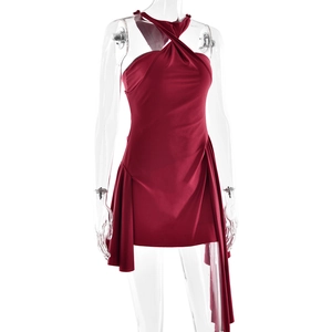 Detail view of red halter neck mini dress with asymmetric hem and backless design