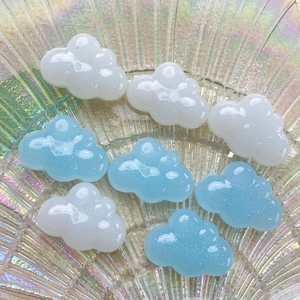 Close-up of sparkling blue and white resin clouds inside an iridescent glass bowl