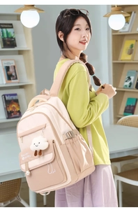 Detail of beige and khaki nylon backpack with Beautiful Holiday text and cloud pendant