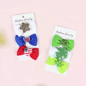 Detail of glitter clover and star bow hair clips for St. Patrick's and patriotic themes