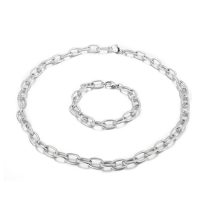 Silver stainless steel twisted curb chain necklace and bracelet set on white background