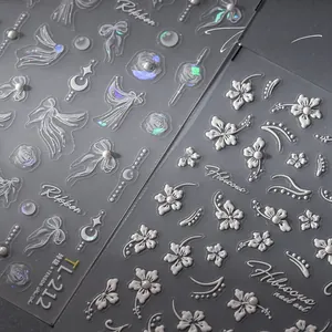 Macro detail of 3D embossed floral nail stickers featuring pearls and ribbons