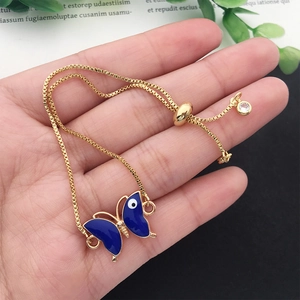 Adjustable gold butterfly bracelet with blue enamel wings and sparkling zircon stone