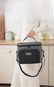 Close-up of grey and black insulated lunch bag with adjustable shoulder strap and FRESH logo