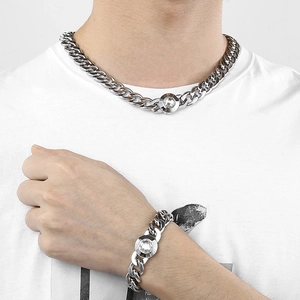 Close-up of silver stainless steel Cuban link necklace set with crystal skull clasp