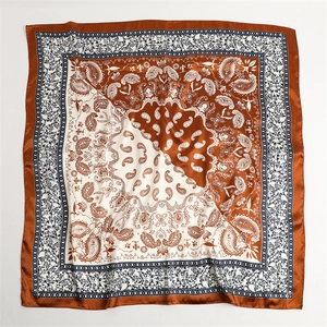 Close-up of caramel and cream silk scarf with vintage paisley print and square design