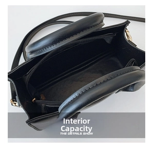Internal capacity of black leather crossbody bag with zipper pocket and gold hardware