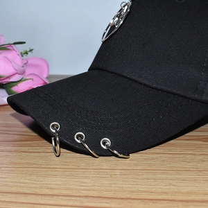Fashionable black cotton baseball cap with silver metal rings on brim for stylish outdoor look