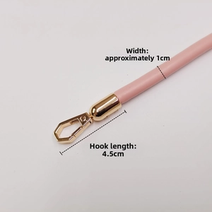 Detail of 1cm pink leather bag strap with 4.5cm gold metal snap hook fasteners