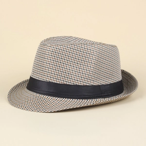 Detail shot of brown and black houndstooth pattern fabric on a classic jazz trilby hat