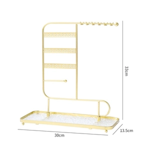 Detail view of 33x30cm gold jewelry stand with tiered hangers and a glass tray