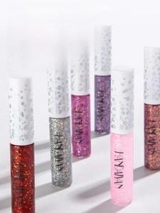 Macro shot of colorful glitter eyeliners in red and silver showing sparkly texture