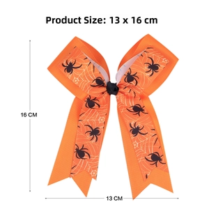Detailed size view of an orange Halloween bow hair clip with spider web patterns