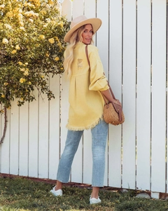 Detail of frayed hem and distressed back on vintage yellow denim shirt jacket