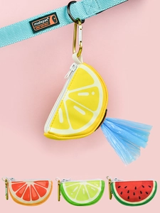 Detail of fruit-shaped pet waste bag dispensers with metal hooks and zipper closure