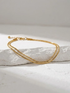 Detail of 18k gold plated double-layer snake and bead chain bracelet with lobster clasp