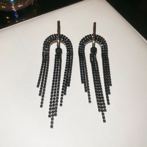 Détail macro de boucles d'oreilles à franges en cristal noir avec un design en U long