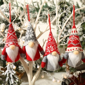 Lighted knitted Christmas gnomes with snowflake patterns hanging on festive tree display