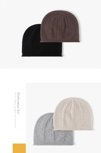 Detailed knit texture of wool beanies in black, brown, white and grey with roll edges