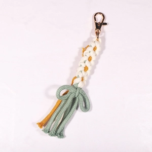 Handmade Macrame daisy keychain with yellow and white woven flowers and green fringe tassel