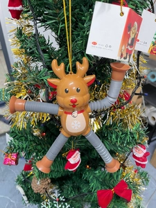 Detail of telescopic elk pop tube toy with suction cup feet hanging on a Christmas tree