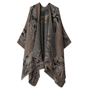Close-up of bohemian paisley knit shawl with intricate patterns in brown and grey
