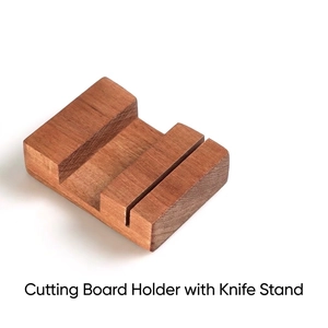 Detail of ebony wood cutting board rack with integrated slots for kitchen knives