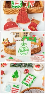 Detail of Christmas fondant cookies featuring Santa socks, trees and festive greetings