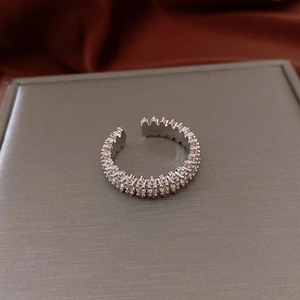 Close-up of adjustable silver star ring featuring zircon micro-pave and sleek design