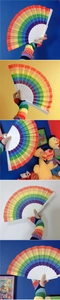 Detailed view of rainbow striped folding fan with white plastic ribs and colorful surface