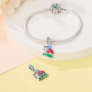 Dettaglio del bracciale a maglia蛇 con ciondoli smaltati a forma di lumaca e fungo