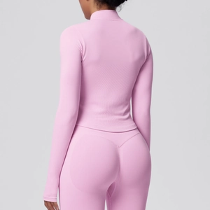 Detail of pink seamless high-stretch fabric on the back of the slim-fit yoga suit