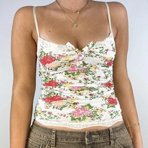 Floral camisole with lace trim, red rose print, and button detail on white fabric