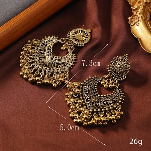 Detail view of retro golden crescent moon earrings with beads, measuring 7.3cm long