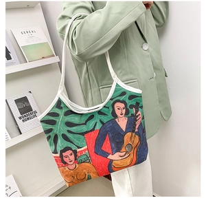 Close-up of artistic canvas tote bag with colorful oil painting print on female model