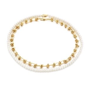 Baroque pearl bead and gold link double-layered stainless steel necklace on white background