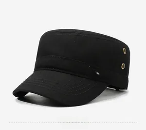 Detail of black military flat cap with silver eagle badge and metal ventilation eyelets