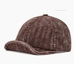 Macro shot of dark brown corduroy texture and stitching on the retro soft brim baseball cap