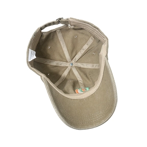 Detail view of khaki washed cotton baseball cap inner structure with adjustable strap