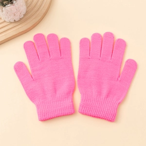 Close-up of rose pink knitted thermal gloves with ribbed cuffs on a neutral background