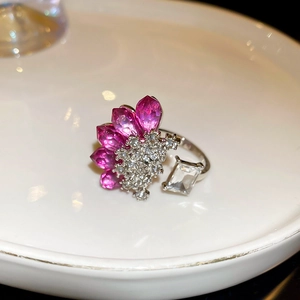 Macro detail of layered open ring with rose pink teardrop stones and rectangle zircon